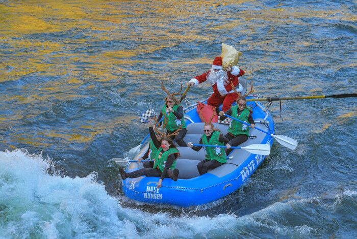 Rafters dressed in Santa and reindeer costumes ride through a whitewater rapid on the Snake River.