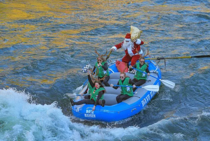 Rafters dressed in Santa and reindeer costumes ride through a whitewater rapid on the Snake River.