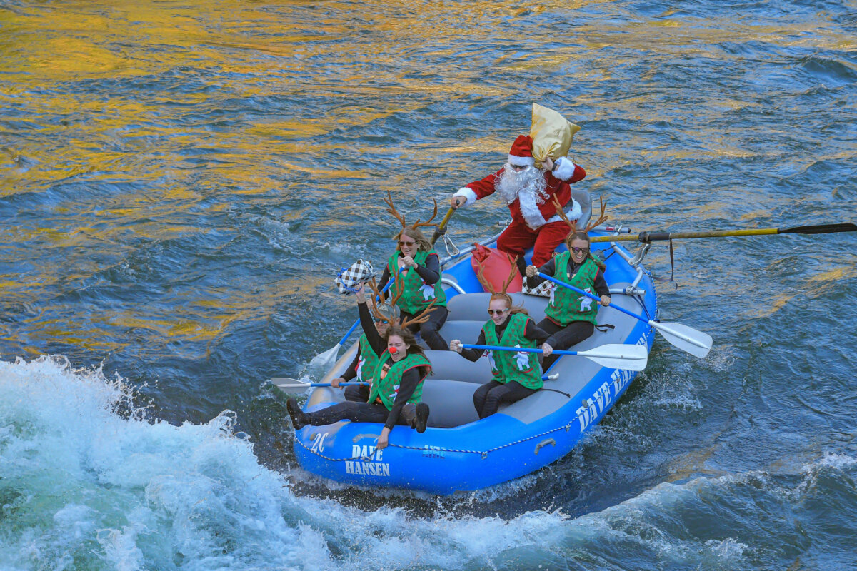 Rafters dressed in Santa and reindeer costumes ride through a whitewater rapid on the Snake River.