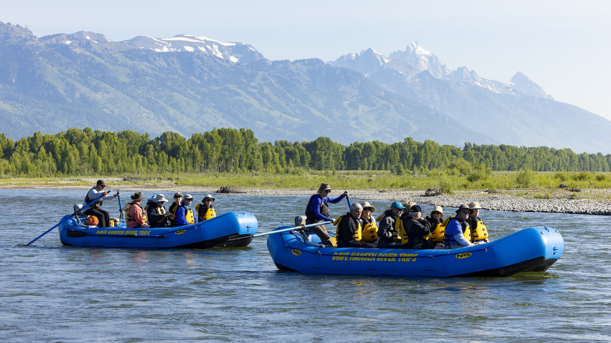 Rafts guides float down a scenic section of the Snake River with views of the Tetons mountains.